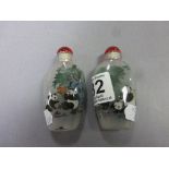 Pair of glass inside painted snuff bottles decorated with panda's