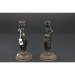 A pair of spelter candlesticks in form of ladies