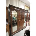 Edwardian Inlaid Mahogany Compendium Wardrobe with a cupboard over four drawers flanked either