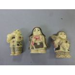 Three netsuke style carvings to include Lady with Parasol