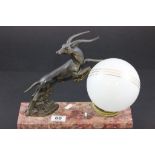 An Art Deco lamp with a spelter figure of a leaping antelope