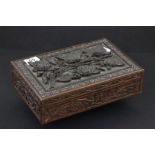 A carved wooden box, the top carved in relief with roses