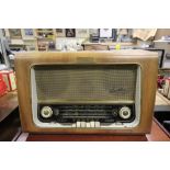 A vintage walnut cased radio by Bush