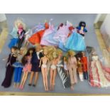 Collection of vintage dolls to include; Barbies and some fashion clothing