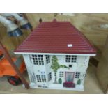 Tri-ang tinplate, plastic and wooden doll house, with a collection of dolls house furniture to
