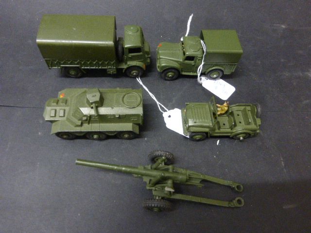 Five Dinky military diecast vehicles and artillery to include Austin Champ, Armoured Personnel