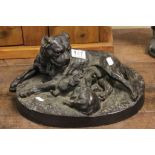 A resin figure of a dog and puppies, signed W.Wolfe