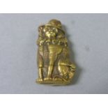 A brass vesta case in the form of a cat in a hat