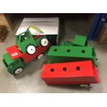 A collection of wooden toys including tractors, carts and others