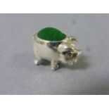 A silver pig pincushion