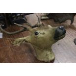 A taxidermy head of a spotted deer