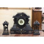 An early 20th century three piece slate clock garniture