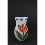 A hand painted Kosta Boda vase, decorated with a single flower