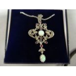 An impressive silver garnet and opal Art Nouveau style pendant necklace on silver chain