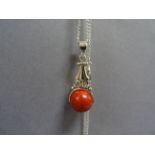 Silver and apple coral necklace with a revolving ball on silver chain