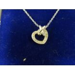 White gold and heart shaped diamond necklace