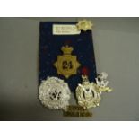 Box of military cap badges and patches