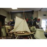 Wooden model of a sailing yacht on stand