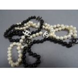 An Opera length string of freshwater black and white pearls with Cartier style spacers