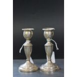 A pair of silver candlesticks, (weighted), London 1933