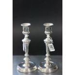 A pair of sliver candlesticks, with mahogany weighted bases, London 1913, 23cm high