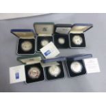 Seven cased silver proof coins to include; £2, £1 & Crowns