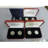 Four cased cased proof coin, medallion sets to include Zambia & Falkland Islands