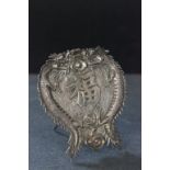 An early 20th century Chinese silver card holder, decorated with dragons chasing a flaming pearl