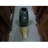 A plaster bust of the green man and a continentel moulded vase decorated with Don Quixote and