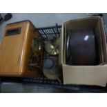 Two vintage brass paraffin lamps, a oak cased mantle clock and a wooden cased radio.