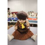 A composition Pedigree doll dressed in a Brownie uniform