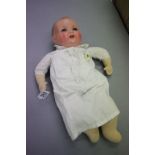 Armand Marseille bisque headed fabric bodied doll with teeth and blue eyes, marked AM Germany 518./3