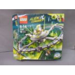 Boxed Lego Alien Conquest 7065 appearing complete with sealed and opened bags, with instructions,