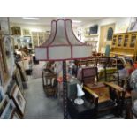 Victorian mahogany bobbin turned standard lamp and shade sitting on bun feet