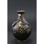 Vintage bronze vase decorated with grapevine