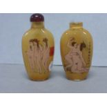 A orientel snuff bottle with erotic decoration and one other .