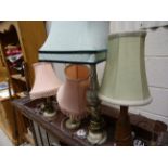 Three onyx pedestal table lamps and one wooden table lamp