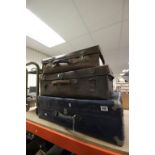 Two vintage leather suitcases plus another