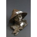 Bronze bust of a boy in hut