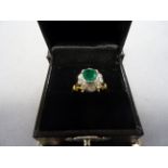 An 18ct yellow gold emerald and diamond daisy style 1.6cts approx