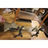 Pair brass and cast metal fire dogs with companion set of fire tools