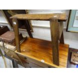 A rustic vintage pine trestle stool