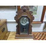 A vintage antique american ginger bread clock.with two train movement.