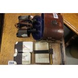 Pair unmarked binoculars in leather case, leather bridge wallet with two packs cards and score pad