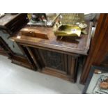 Mahogany cabinet with carved front panel with supporting column either side, 4 squat feet