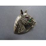 A silver and marcasite horse brooch inset with ruby eyes