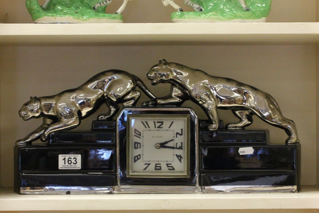 Art Deco Black Ceramic Clock surmounted by Two Silver Coloured Panthers stamped ODYV (Odette