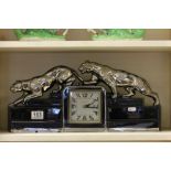 Art Deco Black Ceramic Clock surmounted by Two Silver Coloured Panthers stamped ODYV (Odette