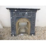 An antique cast metal fireplace.