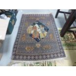 Small Eastern Blue Ground Rug with central panel showing Man and Woman